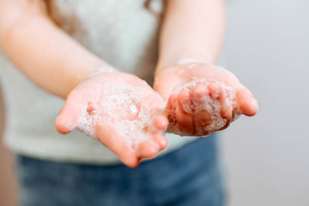 istock Children's hands in soapy foam 1251244735