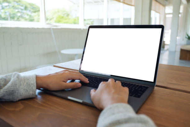 istock a woman using and typing on laptop computer keyboard with blank white desktop screen on wooden table 1251245832
