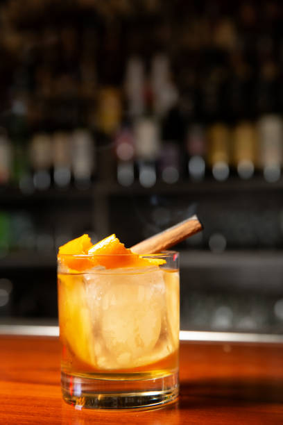 istock Orange cocktail with ice cube and orange zest 1251247010