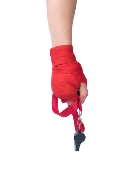 istock hand with protective red bandages holds a whistle isolated on a white background 1251247868