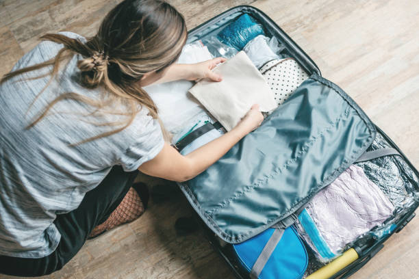 istock A girl is packing clothes 1251254652