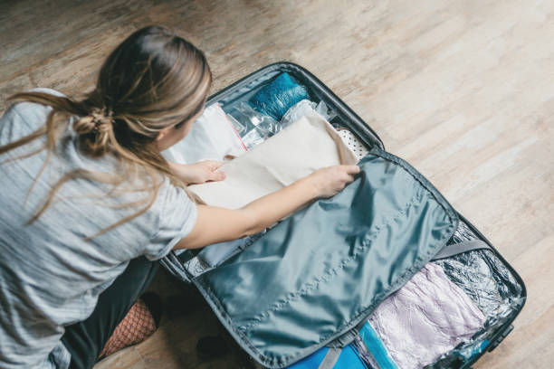 istock A girl is packing clothes 1251254660