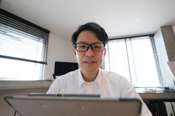 istock Asian businessman talking on video conference from home 1251260332