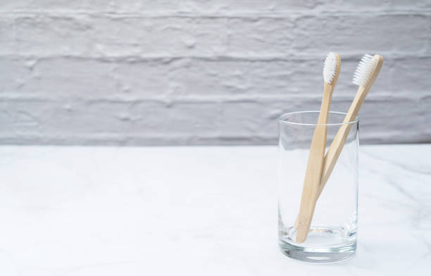 istock A bamboo toothbrush in a cup set against a marble background 1251260772