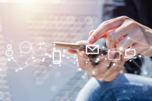 istock Close-up of Woman Using Smart Phone with Polygon Network Graphic and Floating Communication Technology Symbols 1251263410