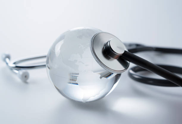 istock A glass globe and stethoscope on a white background. 1251263459