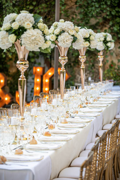istock Luxurious wedding table white and golden with flowers 1251264660