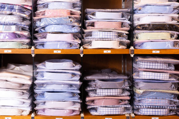 istock Shirts on shelves in shop 1251265573