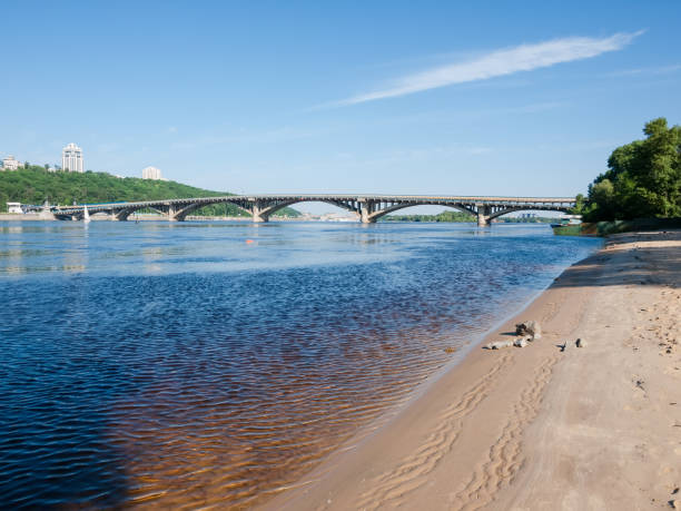 istock Arch concrete bridge across river in springtime, Kyiv, Ukraine 1251267257