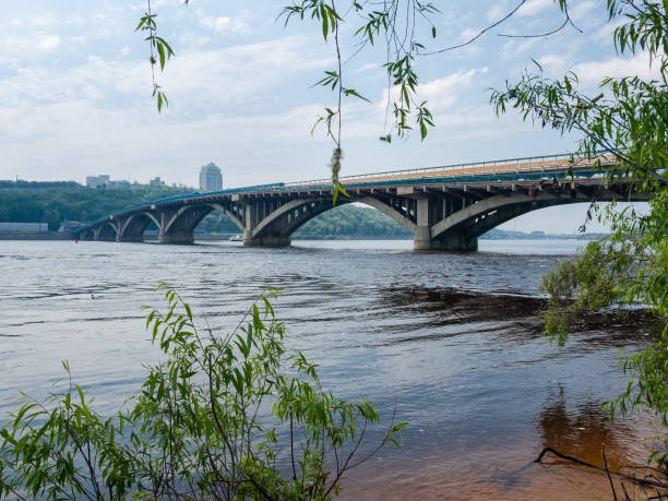 istock Arch concrete bridge across river in springtime, Kyiv, Ukraine 1251267276