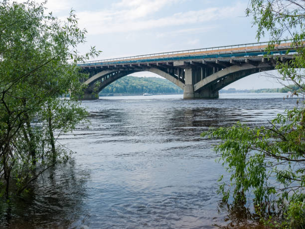 istock Arch concrete bridge across river in springtime, Kyiv, Ukraine 1251268663
