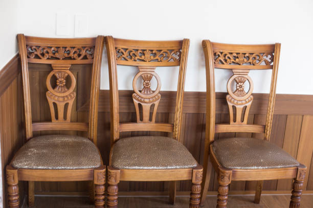istock Three antique brown wooden chairs in cafe. 1251271099