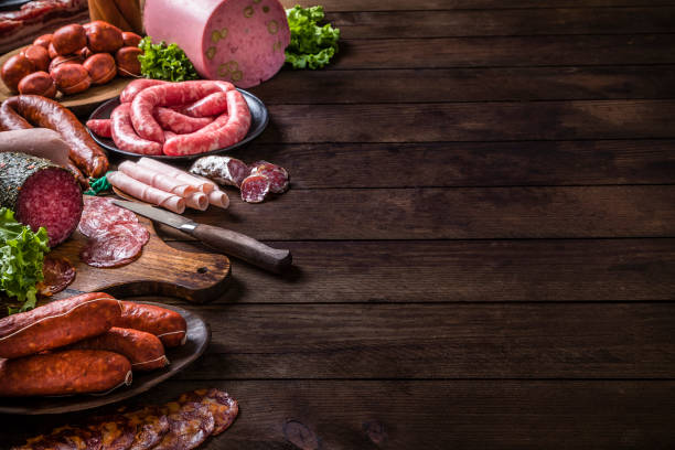 istock Various kinds of raw sausages on a rustic wooden table with copy space 1251271327