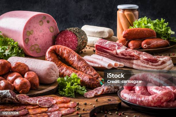 Various Kinds Of Raw Sausages On A Rustic Wooden Table Stock Photo - Download Image Now