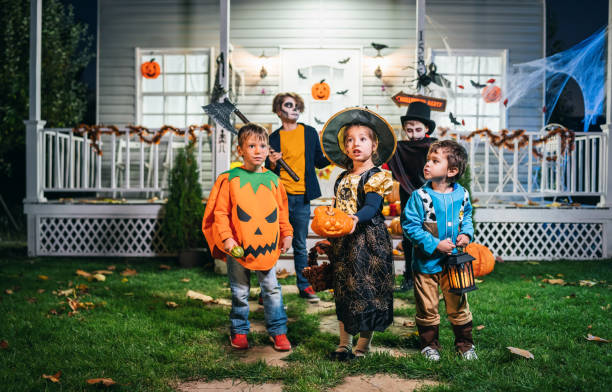 istock Young kids trick or treating at night during Halloween 1251272778