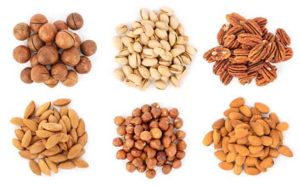 Collection of nuts heaps isolated on white, top view