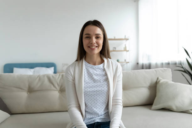 istock Woman looking at camera involved in virtual conference distant communication 1251273665