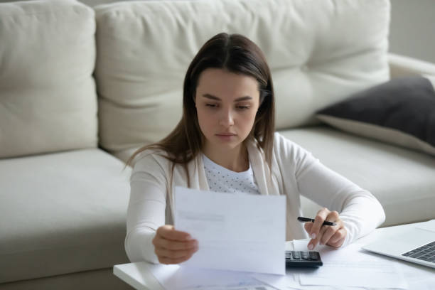 istock Focused woman read notification from bank feels disappointed 1251273781