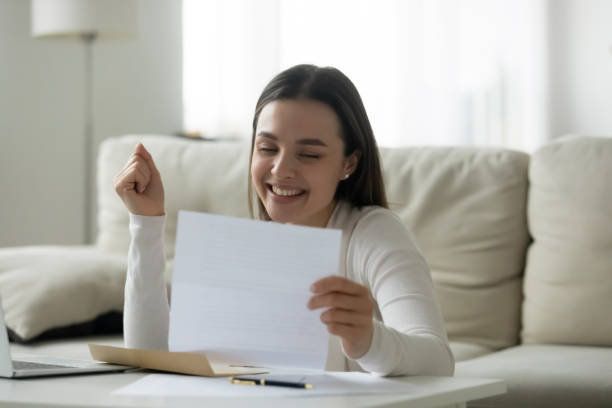 istock Student read letter about getting scholarship university admission feels happy 1251273820
