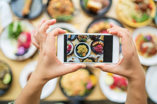 istock Taking photo of food spread on table. 1251273947