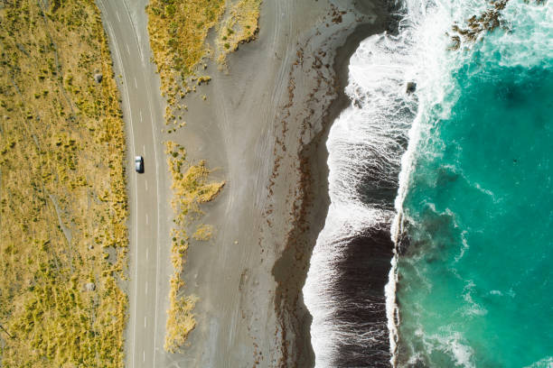 Top view of sea, waves and road. Top view of sea, waves and road in Wairarapa Region, North Island, New Zealand. thoroughfare photos stock pictures, royalty-free photos & images