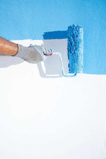 istock Painting a wall in blue 1251274050