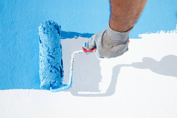istock Painting a wall in blue 1251274085