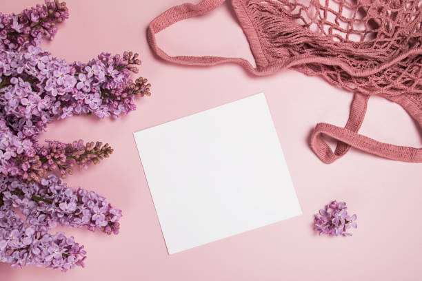 istock Spring composition with lilac flowers, blank paper and string bag 1251274284