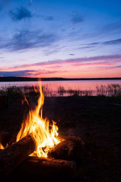 istock evening bonfire on the lake and beautiful sunset in the sky 1251274366