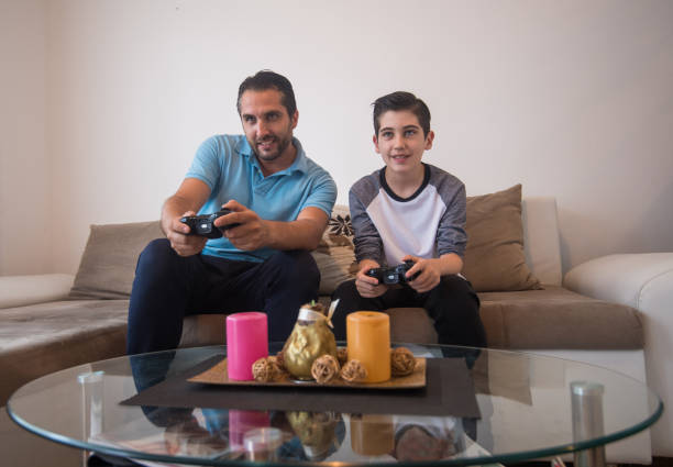 istock Father and son playing video games 1251276733