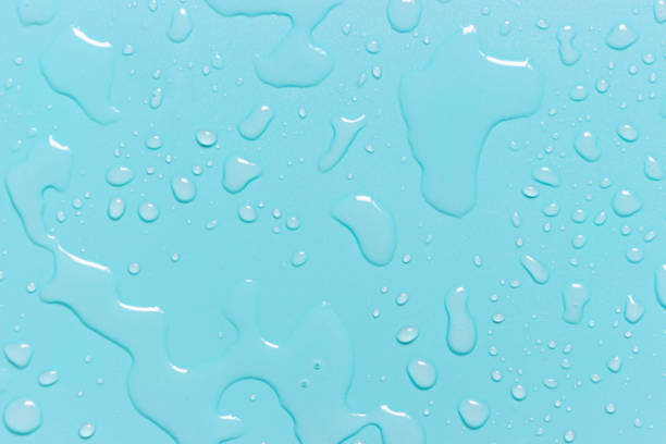 istock Abstract drops of water on a blue background close-up, texture 1251276761