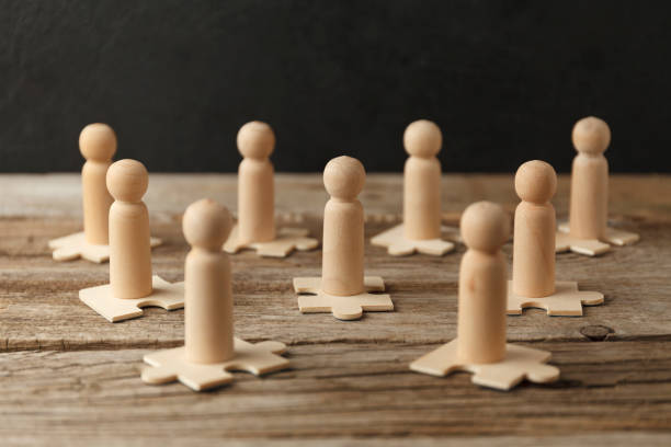 istock Wooden figures on puzzles. People analytics and optimization, team building. Group connection in business 1251277007