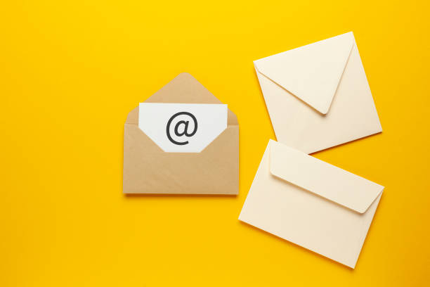 istock Envelope with e-mail symbol on yellow background, concept of corporate communication and marketing mailings 1251277050