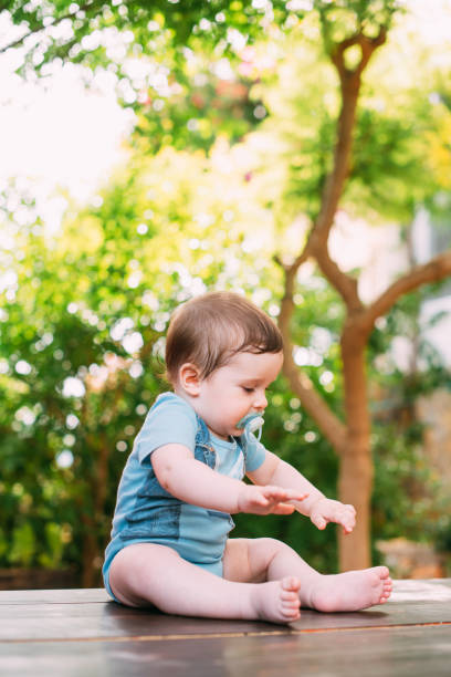 istock Lactating Baby Boy Sitting on the Garden 1251277427
