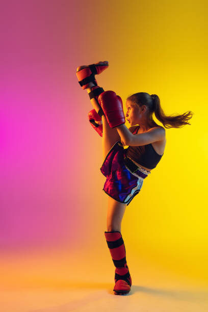 istock Little caucasian female kick boxer training on gradient background in neon light, active and expressive 1251280051