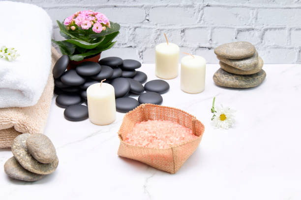 istock Spa bath salts next to some towels and candles on a marble table 1251280182