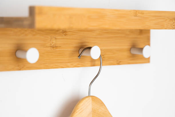 istock Clothes wooden hanger on a white wall. 1251280328