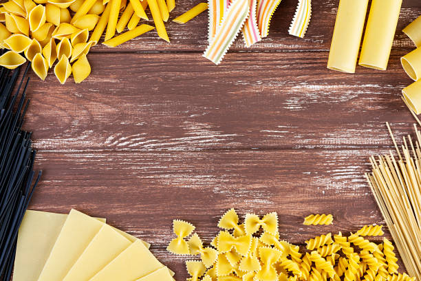 istock Different dry pasta on a wooden background. Top view 1251281054