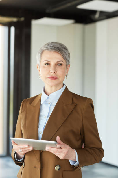 istock Mature businesswoman using tablet pc 1251285795