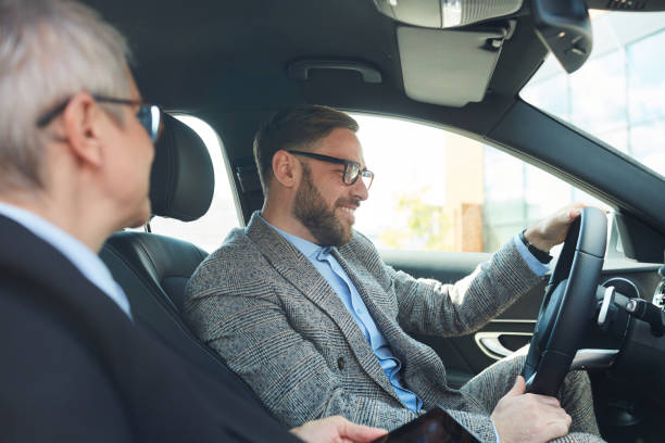 istock Business colleagues driving by car 1251286102