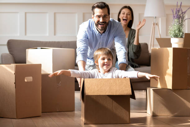 istock Excited parents with little son having fun on moving day 1251286975