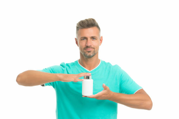 Vital for bone health. Vitamins and minerals. Essential for immune system. Side effects. Medicines concept. Food additives vitamins for male health. Vitamins complex. Handsome man presenting product.