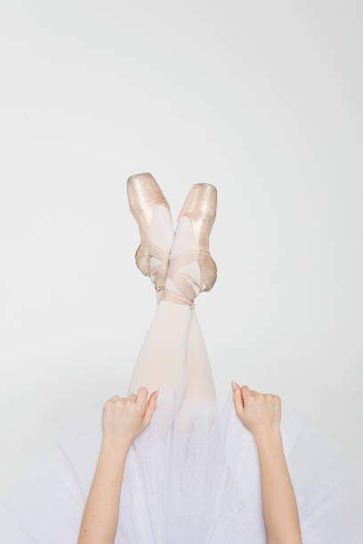 istock Ballerina legs in light classic pointe shoes 1251288491