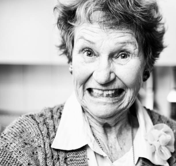 istock Senior woman looks amused and surprised as she pulls a face 1251289654