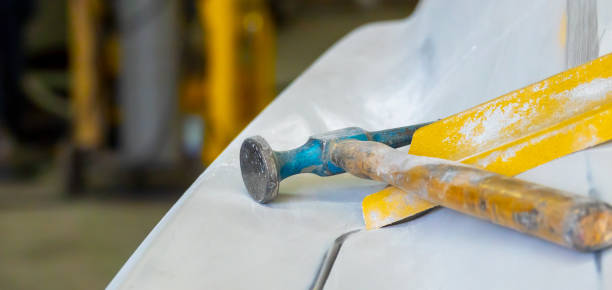 istock Auto mechanic working on car paint sanding in mechanics garage. workshop repair service. authentic close-up shot. 1251290890