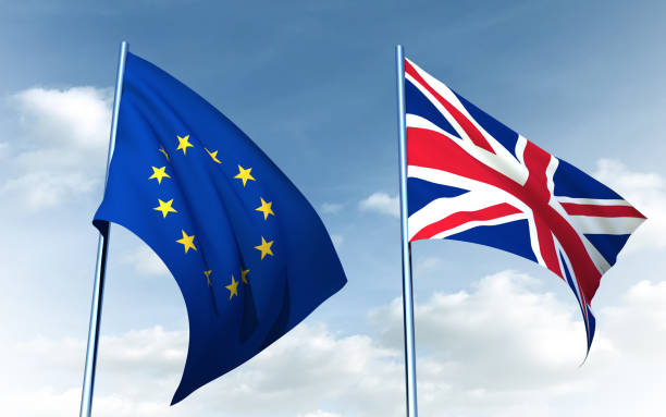 istock Brexit concept. British flag and EU flag on a sky background 1251291284