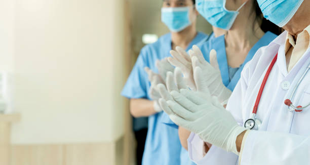 closeup hand applaud from doctor and nurse support,Clapping medical workers blur hospital background closeup hand applaud from doctor and nurse support,Clapping medical workers blur hospital background covid crowd stock pictures, royalty-free photos & images