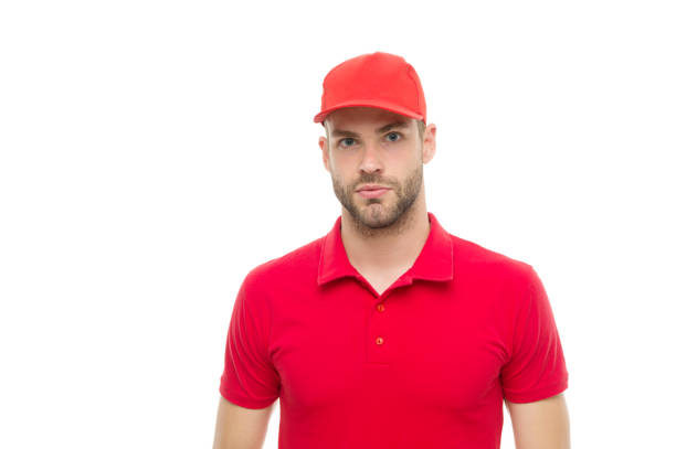 istock Working for your comfort. Man delivery service. Guy in red cap isolated on white background. Express courier service. Shipping and delivery service. Post worker. Help with relocation and move out 1251293895