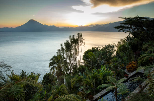 sunset over Lake Atitlan from a tropical garden