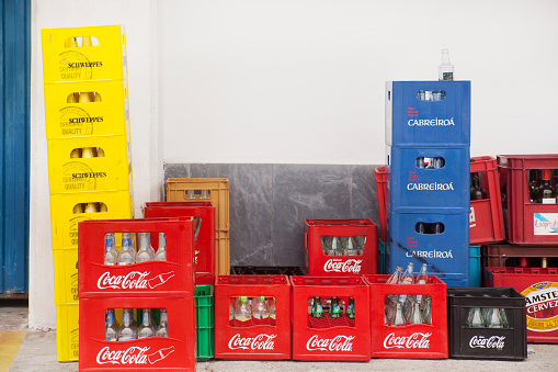 Spain, Barselona, October 14, 2022 Empty bottles from Coca Cola original taste drinks in a red box. Reuse and recycling, care for the environment. The carbonated soft drink